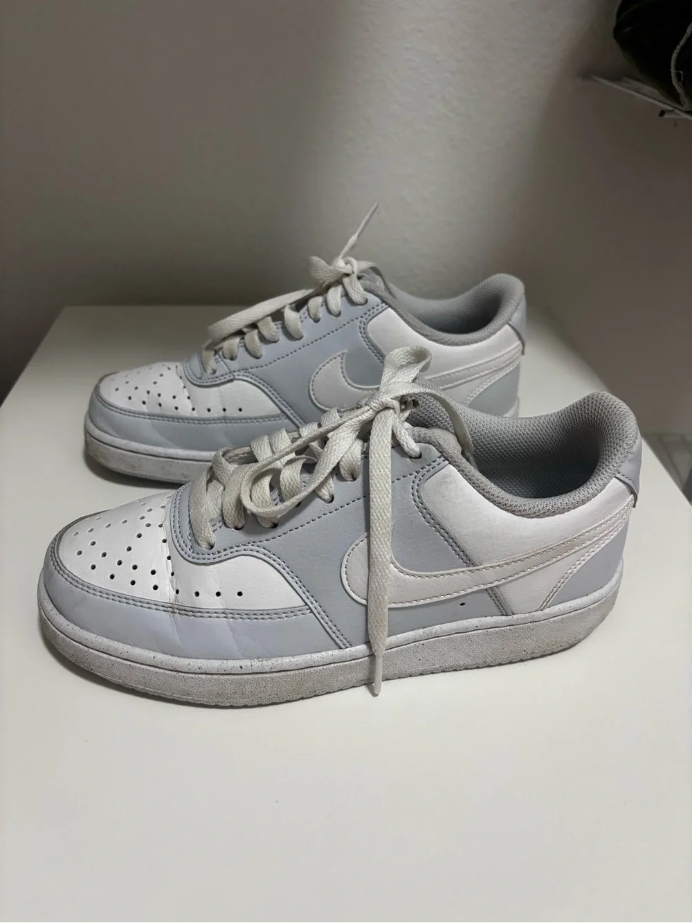 Nike White and Light Gray Low-Top Swoosh Sneakers courtesy of vision’s lows